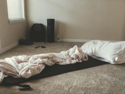 Water bottle on a mat in a dark studio.